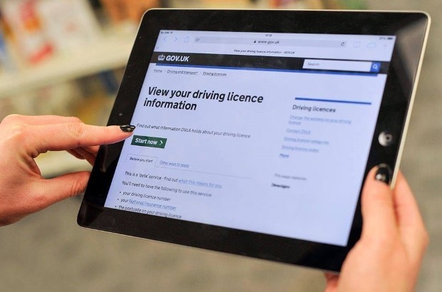 Person using an iPad to use the GOV.UK 'view driving licence information' page