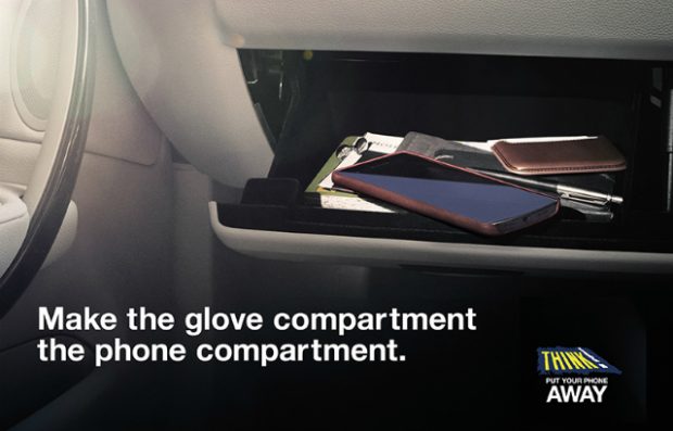 A mobile phone in a glove compartment.