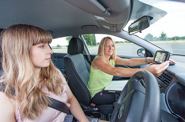 Driving examiner setting up a sat nav