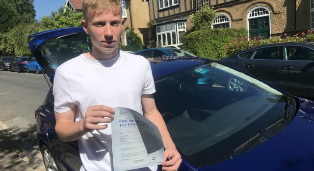 Finbar King holding driving test pass certificate