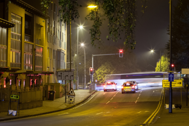 Photo showing traffic stopped at traffic lights at night