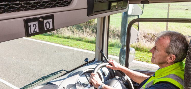 Lorry driver in cab on the road