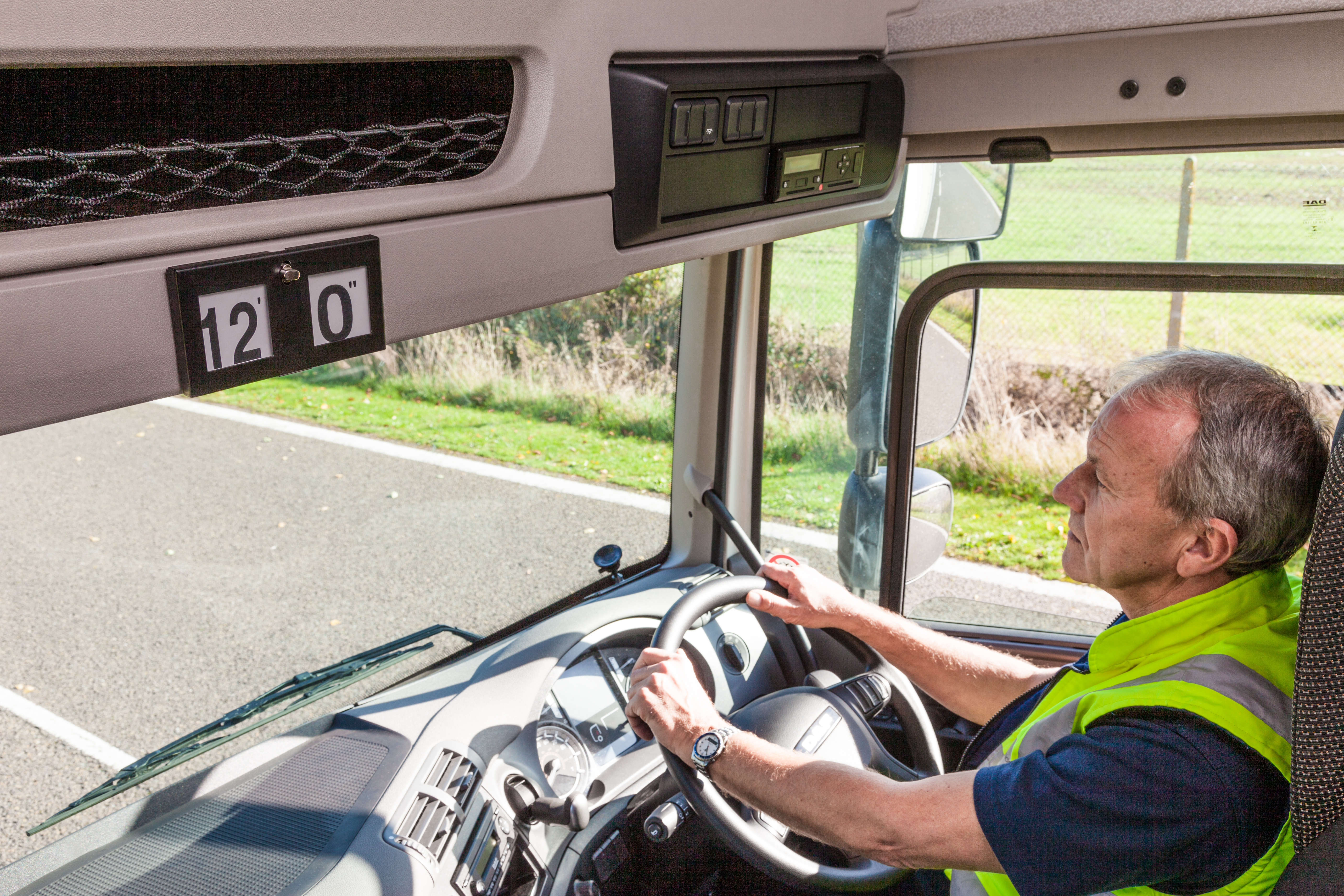 Lorry driver in cab on the road